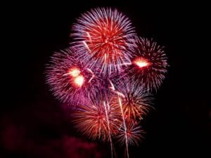 Colorful fireworks burst in a night sky